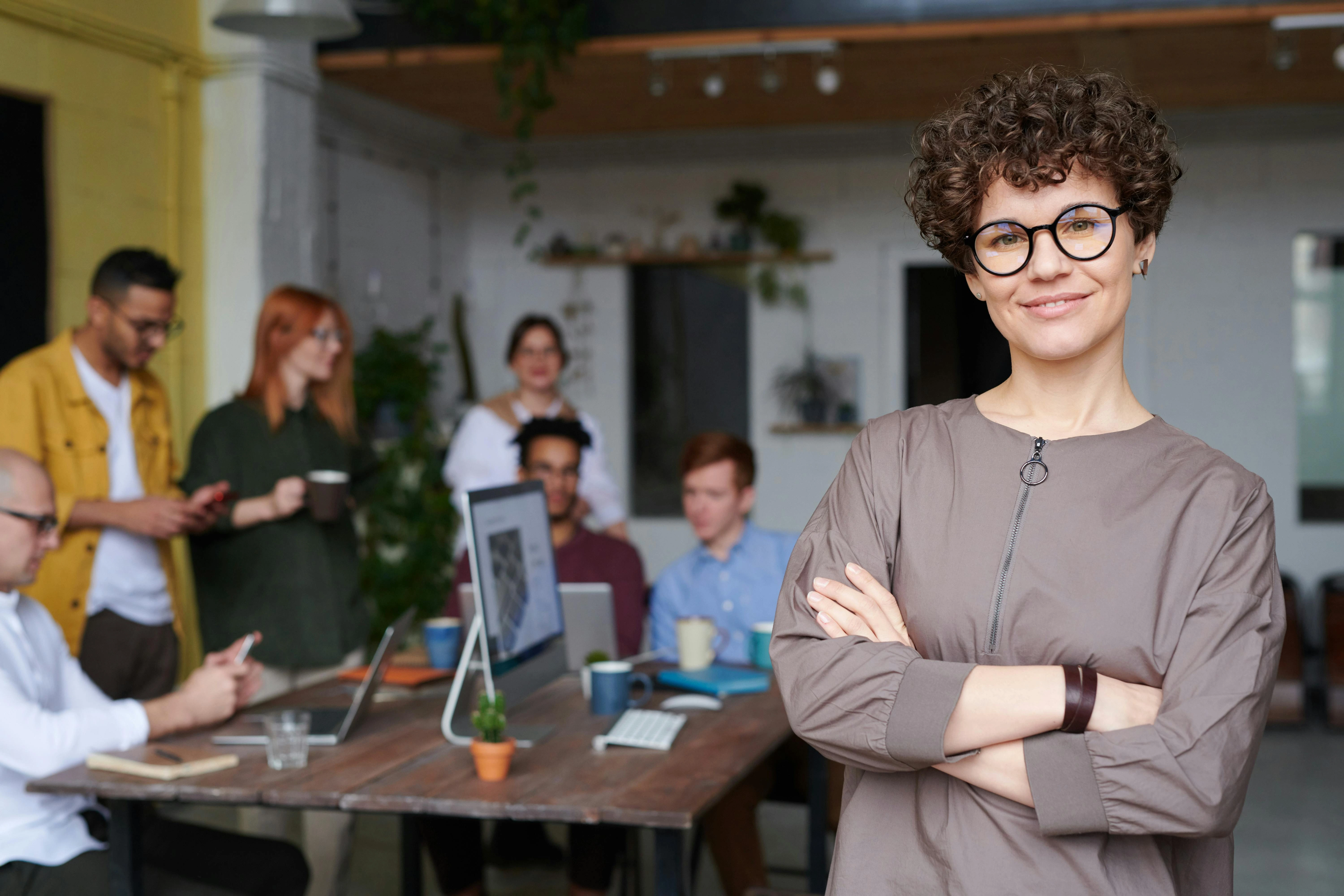 an image showing a happy employee, other employees in background